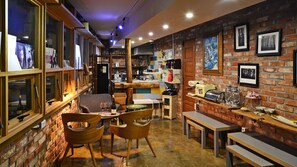 Un restaurant chaleureux avec des murs en briques, des meubles en bois et divers appareils de cuisine.