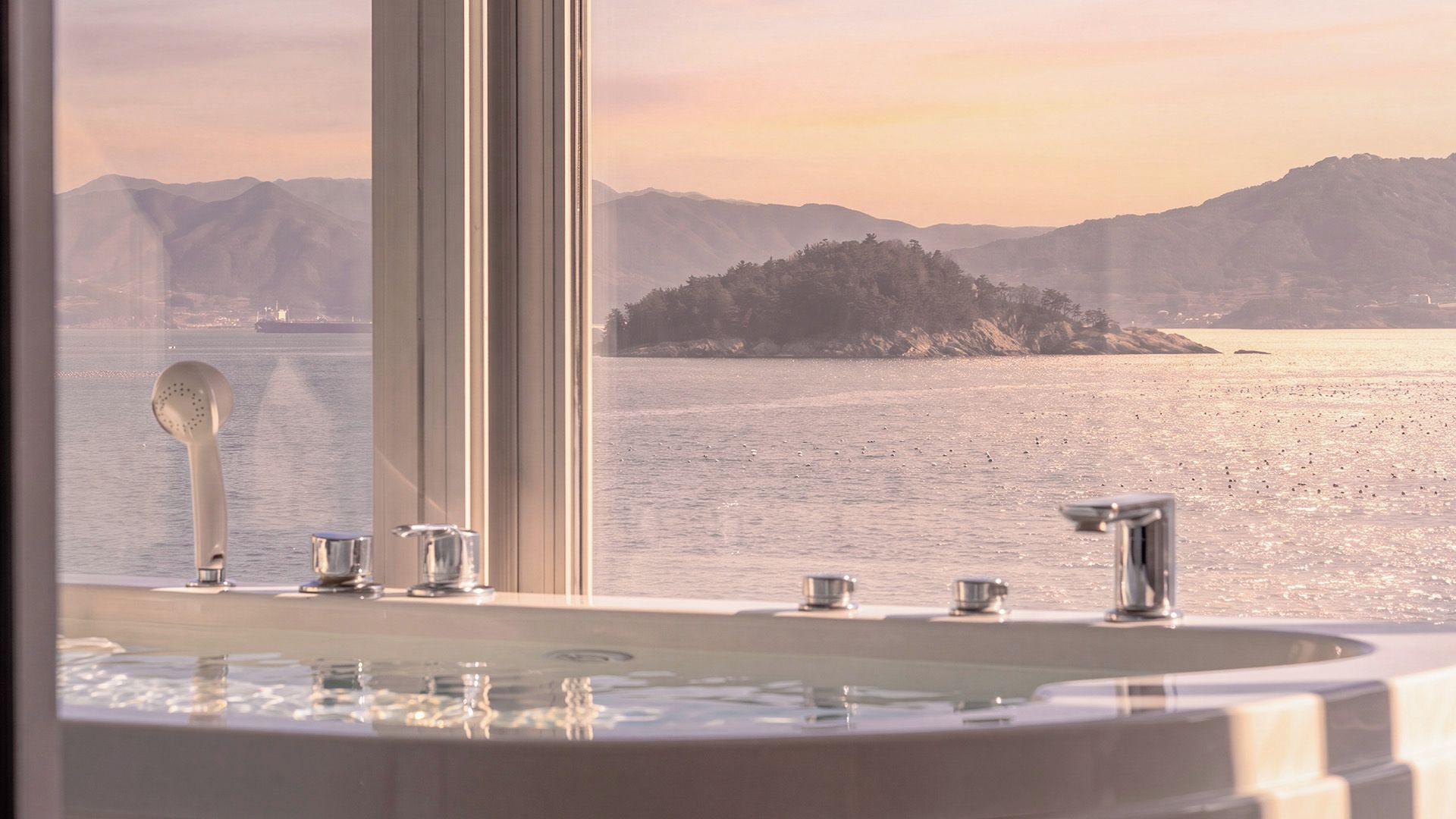 A bathroom with a bathtub, a shower, and a sink.