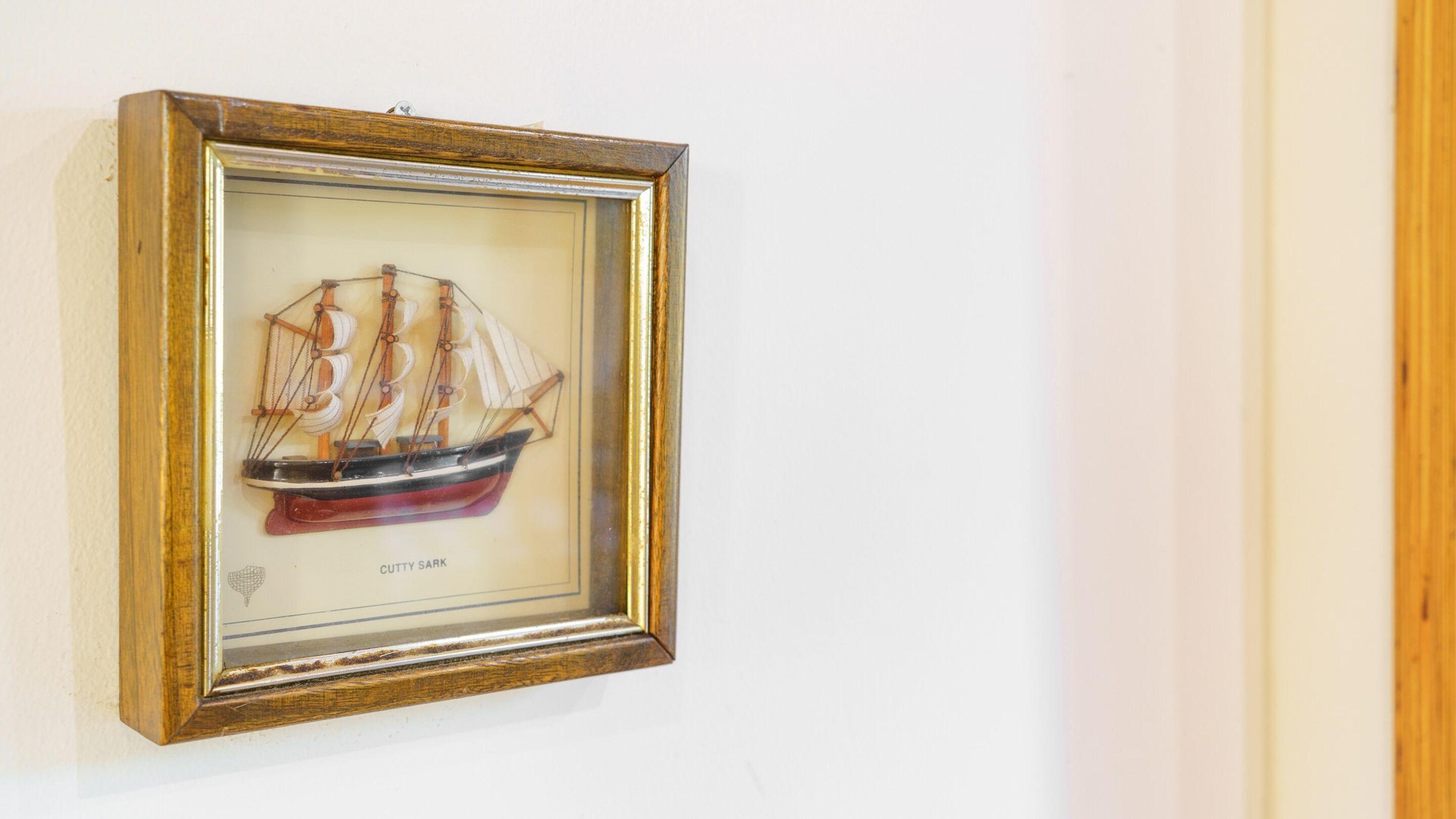 A framed artwork of a Cutty Sark ship.