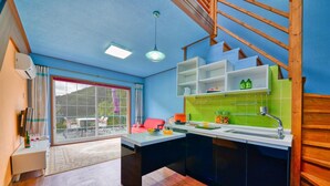 A modern kitchen with a built-in oven, a sink, and a window overlooking a balcony. - Yangpyeong Yoon & Park Spa Pension (Yangpyeong)