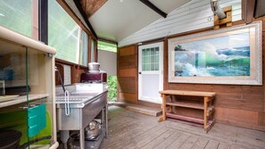 A kitchen with a large stove, a sink, and a window overlooking a garden. - Gapyeong Good Morning House Pension (Gapyeong)