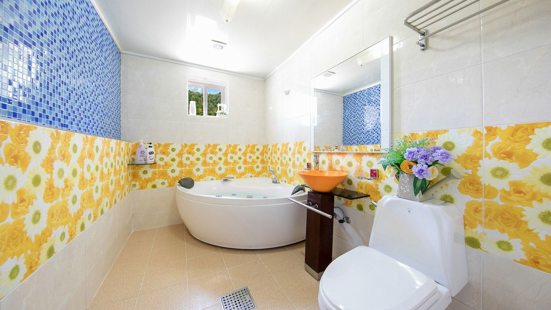 A bathroom with a bathtub, toilet, and sink.