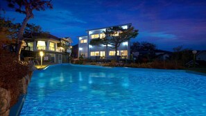 A modern two-story building with a swimming pool in front. - Ganghwa Ana Island Pension (Incheon)
