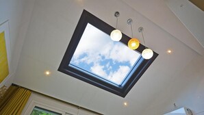 A skylight with a clear view of the sky and three hanging spherical lights. - Gyeongju Green Valley Spa Pension (Gyeongju)