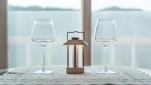 Two wine glasses on a lace doily with a small lantern between them. - Hongcheon On The Hill Pension (Hongcheon)