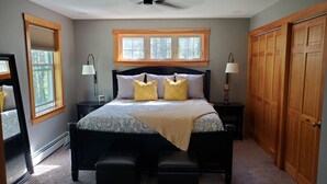 A bedroom with a bed, two bedside tables, a ceiling fan, a window, and a wardrobe. - If you want privacy, look no further! (Arundel)