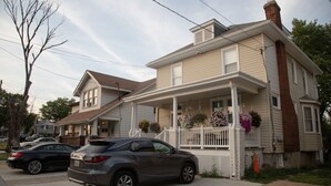 A two-story house with a porch, a garage, and a driveway.