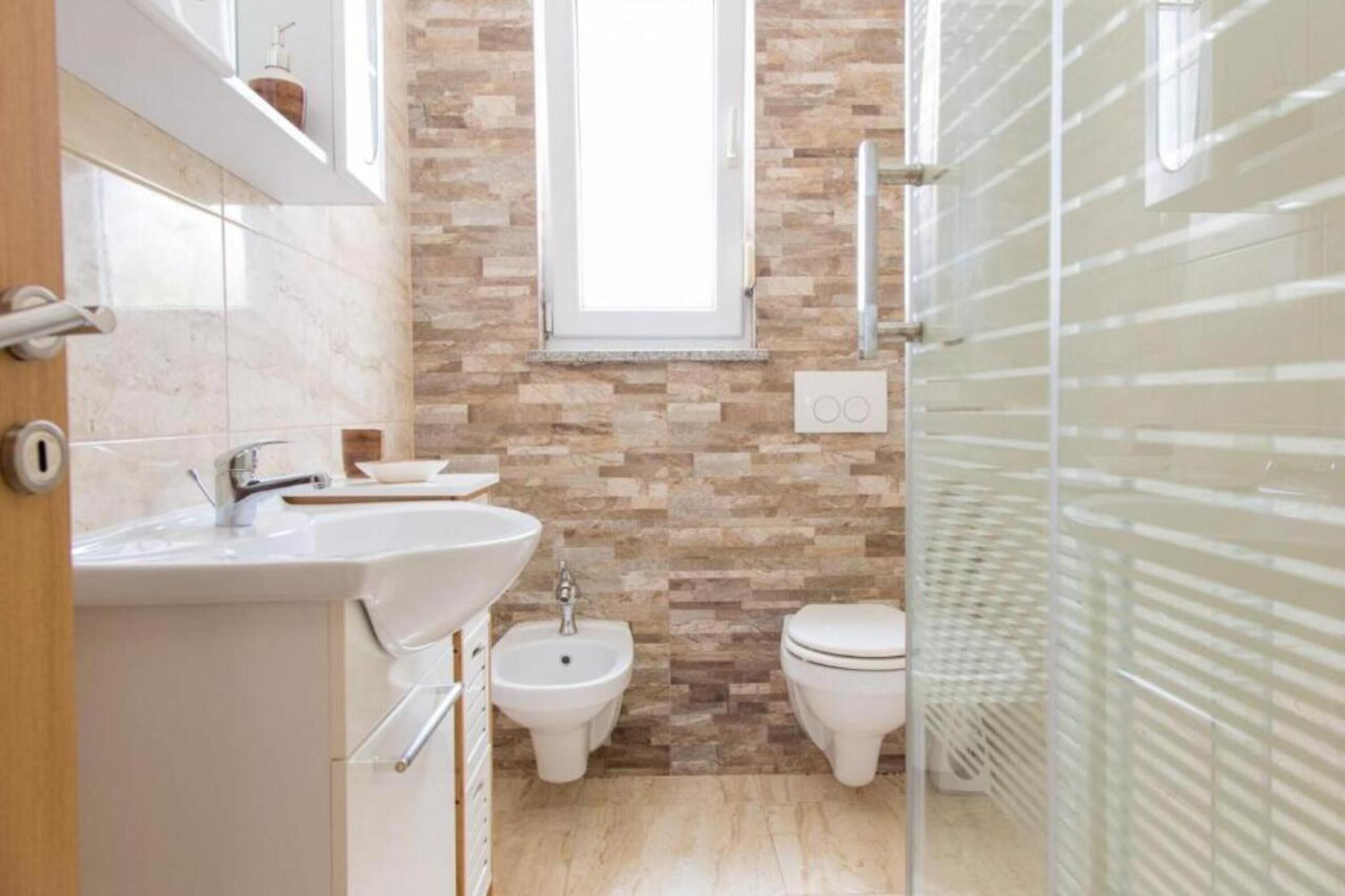 Appartement Deluxe | Salle de bain | Douche, douche à « effet pluie », bidet, serviettes fournies