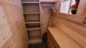 A wooden interior with a bench, shelves, and a window. - Cozy chalet in Les Gets center, 4-5 ppl, balcony, garage (Les Gets)