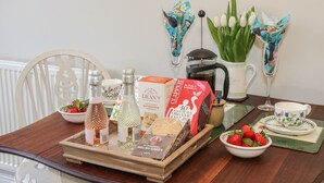 A breakfast tray with various food items and drinks on a wooden table.