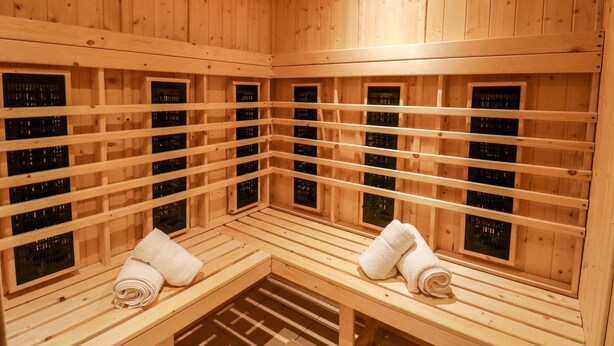 A wooden sauna with benches and individual steam rooms. - Seafarers (Scarborough)