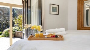 A bedroom with a bed, a tray with breakfast items, a vase with flowers, and a framed picture on the wall. - Protestant Hall - complete peace and tranquility (Wildes Meadow)