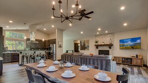 A spacious kitchen with a large island, modern appliances, and a dining area with a wooden table set for six. - Built in 2021, Chef's Kitchen, Classic Arcade, 200mbps Wifi, Grill, Close to Heavenly: North Woods (South Lake Tahoe)