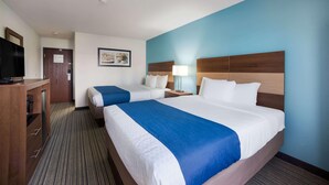 A hotel room with two beds, a desk with a television, and a framed picture on the wall. - Ramada by Wyndham Effingham (Effingham)