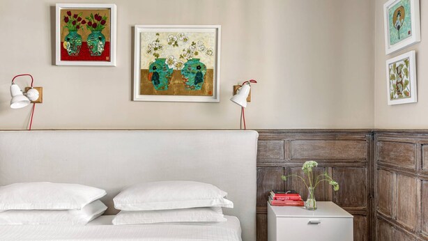 A hotel room with a bed, bedside table, and wall-mounted artwork. - Cockspur Street by onefinestay (London)