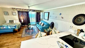 A compact living space with a bed, a sofa, a dining table, and a kitchenette. - Pheapie Beach Retreat, Beachfront, W/ Air Conditioner, Large Lanai (Hauula)