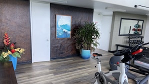 A modern home gym with a stationary bike, treadmill, and weights. - Pheapie Beach Retreat, Beachfront, W/ Air Conditioner, Large Lanai (Hauula)