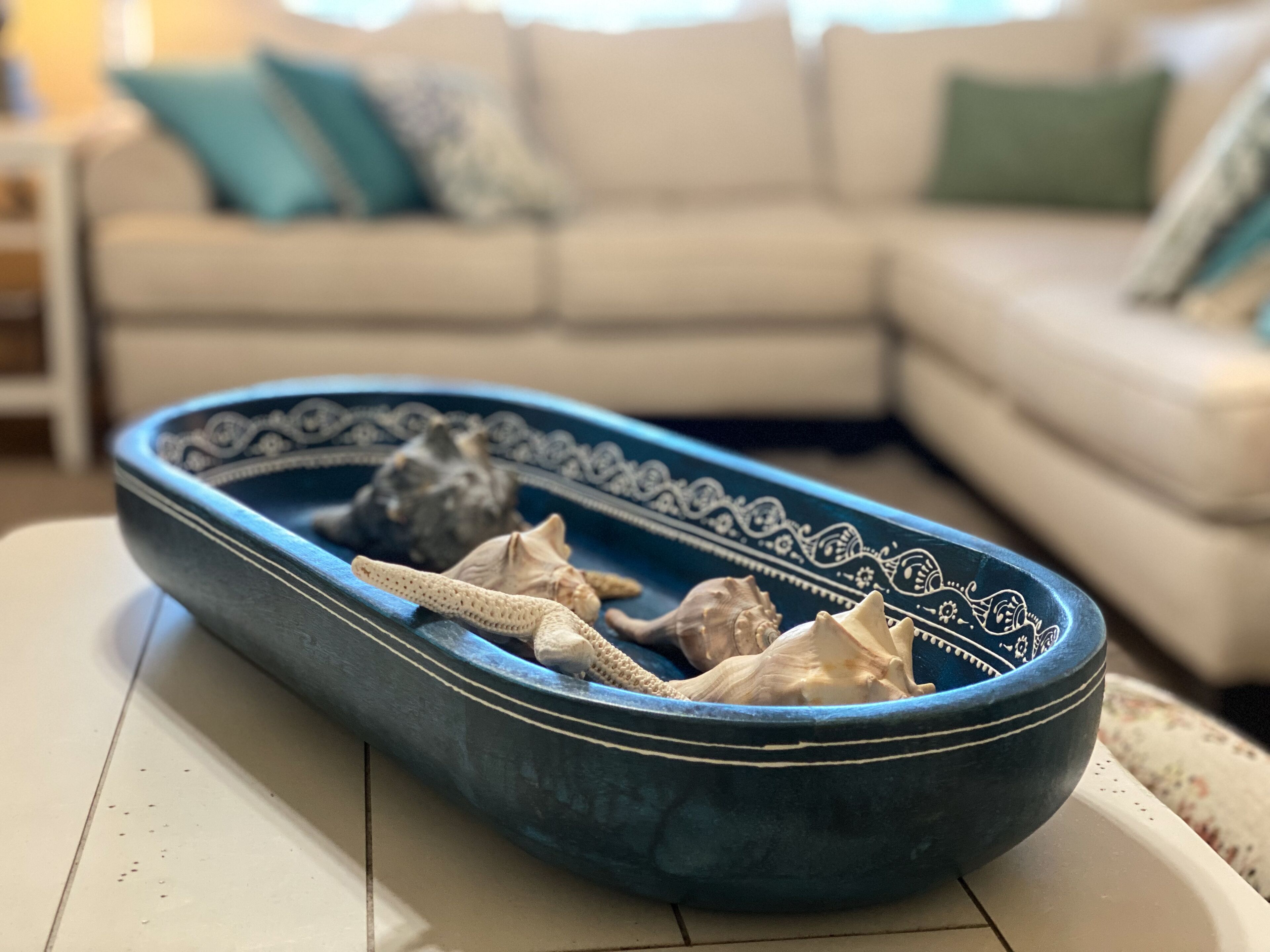 A blue ceramic bowl with decorative patterns on a white surface.