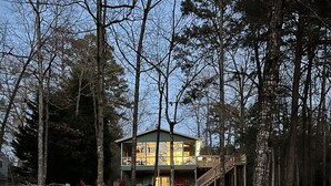 A pathway leading to a two-story building surrounded by trees. - THIRTEEN FEET of water at our dock currently SUPER CUTE On the lake, Deep Water  (Hartwell)