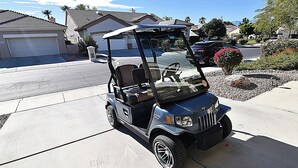 A golf cart parked on a residential driveway. - Palm Valley CC Remodeled beauty, 2b 2ba on 6th fairway w/golf cart, club access. (Palm Desert)