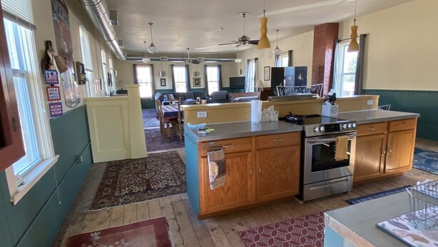 A spacious kitchen with wooden cabinets, a central island, and a built-in oven. - Spacious Loft in Downtown Lewiston  (Lewiston)