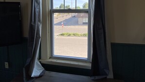 A room with a window featuring a view of a street and a parking lot. - Spacious Loft in Downtown Lewiston  (Lewiston)