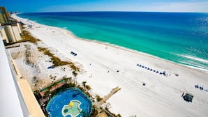 A beach resort with a pool, white sand, and a clear blue sea. - Boardwalk Beach Resort Unit 905 (Panama City Beach)