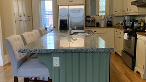 A kitchen with a central island, a built-in oven, and a stainless steel refrigerator. - Victorian Home near downtown, Georgian Bay and many bike & hiking trails (Collingwood)