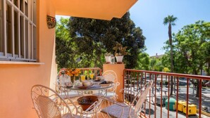 A balcony with a table and chairs, a railing, and potted plants. - Rincon Dorado by Interhome (Torremolinos)