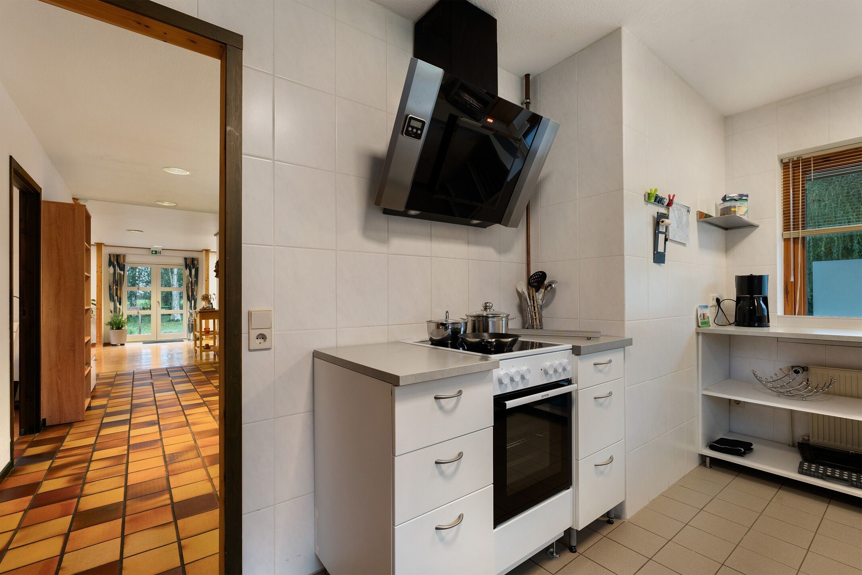 Una cucina con forno a incasso, microonde e piano cottura a gas.