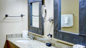 A bathroom with a granite countertop, a sink, a mirror, and a towel rack. - Free EV Charger in 2 Car Garage-3 enSuites-EZ Walk to Resort/Free Town Bus-W/D in Unit-Dogs OK (Steamboat Springs)
