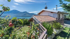 A house with a terrace, a mountain view, and a lake.