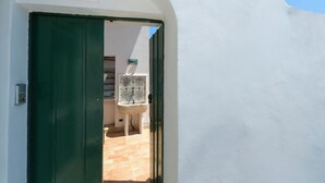 A doorway leading to a room with a tiled floor, a white sink, and a chair. - Seaside, near the elevator, just a few steps away, and parking available (Positano)