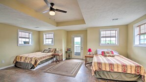 A bedroom with two beds, a ceiling fan, and a door leading outside. - Secluded Angler's Haven - Boat + Fish! (Rosston)