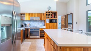 Una cocina moderna con armarios de madera, electrodomésticos de acero inoxidable y una isla grande.