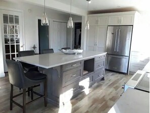 Enjoy cooking in this well-equipped kitchen with a spacious island, ample counter space, and modern cabinetry.