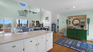 A spacious kitchen with a large island, white cabinetry, and a view to the outdoors. - CABANA DEL SOL IS A 2BD/2BA GULF FRONT W/AMAZING VIEWS, 2 SCREEN PORCHES! (Port Saint Joe)