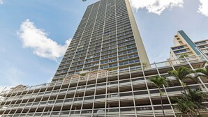 A high-rise building with multiple balconies and a clear sky. - Golf Course & Mountain Views at the Island Colony Amazing Building Amenities (Honolulu)