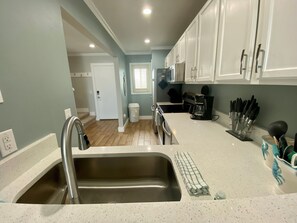 Microwave, coffee/tea maker, toaster, cookware/dishes/utensils