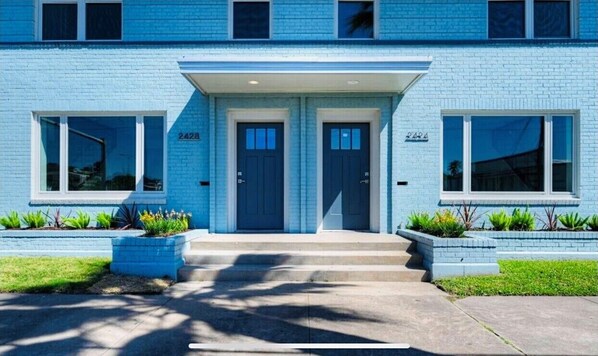Stunning two-story residence with a central entrance and beautifully manicured lawn.