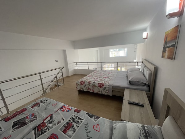 Enjoy a restful stay in this cozy room with a single bed, bedside table, and balcony offering a view of the outside.