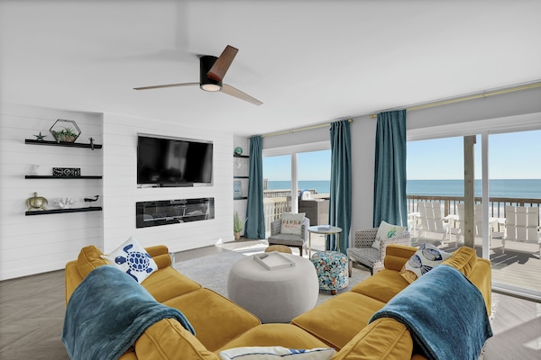 Spacious living room with large TV, modern fireplace and unbeatable ocean views!