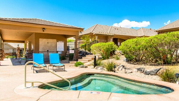 A swimming pool with lounge chairs and a covered patio area. - Two heated pools/spas, pond, backyard w/ BBQ (Washington)