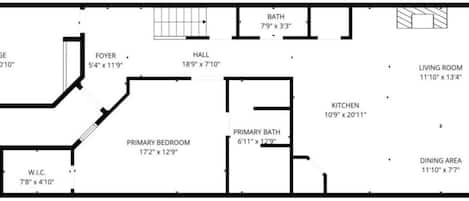 A floor plan with a garage, foyer, primary bedroom, primary bath, kitchen, dining area, living room, and balcony.