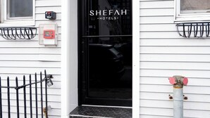 A hotel entrance with a black door, numbered 3307, and a sign above the door reading "SHEFFAH HOTELS". - Shefah Hotel (Union City)