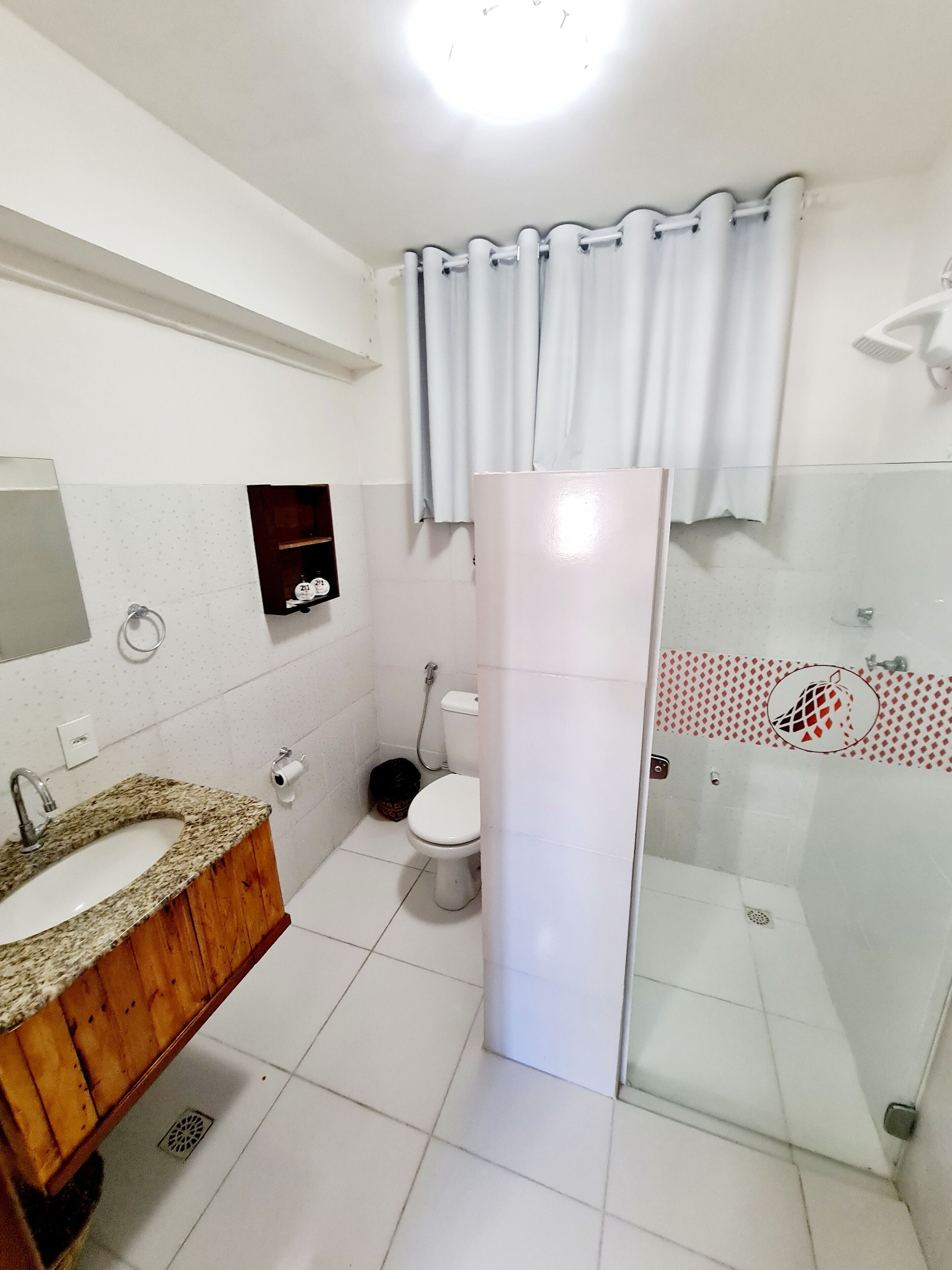 A bathroom with a sink, toilet, and shower.