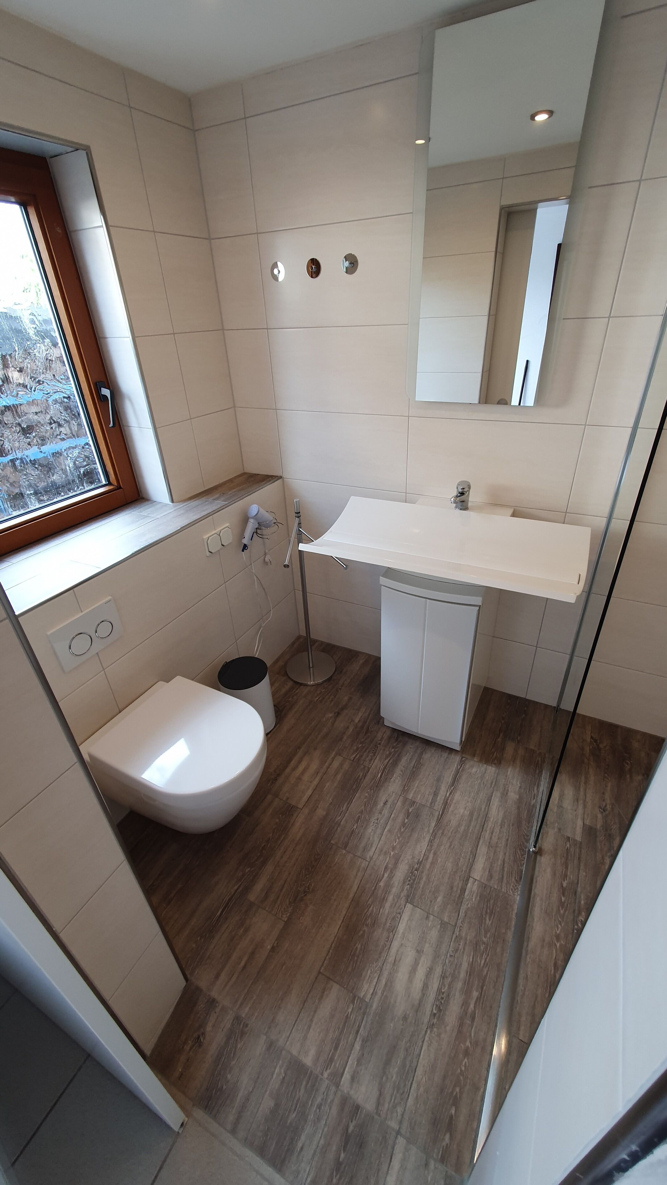 A modern bathroom with a toilet, bidet, and sink.