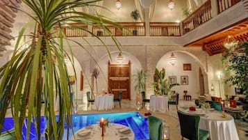 Enjoy dining in style with a central pool and elegant lighting fixtures.
