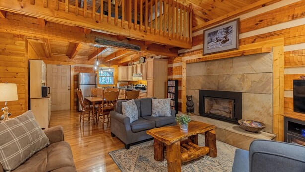 A cozy cabin interior with a living room, dining area, and kitchen. - Creekside, Hot Tub, Fire Pit, Fireplace, Quiet, Easy Access (Cosby)