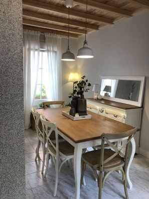 Enjoy meals in this cozy dining area with a wooden table and six comfortable chairs.